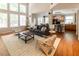 Bright living room with hardwood floors, large windows, and open access to the kitchen at 5129 Bartons Enclave Ln, Raleigh, NC 27613