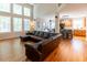 Open-concept living room with hardwood floors, large windows, and access to the kitchen and dining area at 5129 Bartons Enclave Ln, Raleigh, NC 27613