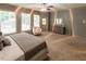 Spacious main bedroom with plush carpeting, a ceiling fan, dresser, and ample natural light at 5129 Bartons Enclave Ln, Raleigh, NC 27613