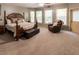 Spacious main bedroom with large windows, comfortable seating, and a king sized bed at 5129 Bartons Enclave Ln, Raleigh, NC 27613