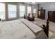 Inviting main bedroom featuring soft carpet, a king-sized bed, and lots of natural light at 5129 Bartons Enclave Ln, Raleigh, NC 27613