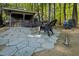 Outdoor entertainment area featuring a stone patio with a fire pit and outdoor kitchen at 5129 Bartons Enclave Ln, Raleigh, NC 27613