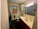 Functional bathroom with a single vanity, vinyl tile flooring, and a shower/tub combo at 543 Stockyard Rd, Staley, NC 27355