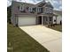Beautiful two-story home featuring a spacious driveway and well-maintained front lawn at 567 Winding Creek Dr, Lillington, NC 27546