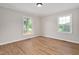 Bedroom featuring wood-look floors, neutral paint, and two windows for natural light at 603 Warren Rd, Erwin, NC 28339