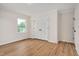 Bedroom featuring wood-look floors, neutral paint, two closets, and a window at 603 Warren Rd, Erwin, NC 28339