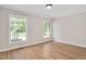 Bright bedroom features wood-look flooring, neutral walls, and two windows at 603 Warren Rd, Erwin, NC 28339