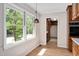 Cozy breakfast nook featuring bright windows, stylish pendant lighting, and wood cabinets nearby at 603 Warren Rd, Erwin, NC 28339