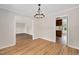 Bright dining room boasts hardwood floors and a modern chandelier, creating an inviting atmosphere at 603 Warren Rd, Erwin, NC 28339