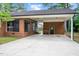 Inviting covered parking area featuring classic brick architecture and a well-maintained lawn at 603 Warren Rd, Erwin, NC 28339