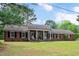 Beautiful one story red brick home with manicured lawn and charming front porch with white columns at 603 Warren Rd, Erwin, NC 28339