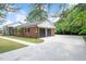 Charming brick home with a wide driveway and well-manicured lawn at 603 Warren Rd, Erwin, NC 28339
