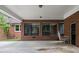 Charming covered patio featuring brick accents and comfortable seating at 603 Warren Rd, Erwin, NC 28339