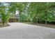 Wide driveway leading to a covered parking area with a spacious, tree-shaded yard at 603 Warren Rd, Erwin, NC 28339