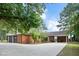 Expansive driveway and a large covered parking area enhance this well-maintained brick home at 603 Warren Rd, Erwin, NC 28339