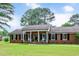 Charming red brick home with a covered front porch and well-manicured lawn, perfect for curb appeal at 603 Warren Rd, Erwin, NC 28339