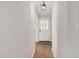 Bright hallway featuring wood-look flooring, neutral paint, and a stylish front door with glass inserts at 603 Warren Rd, Erwin, NC 28339