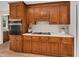 A close-up view of the kitchen, featuring wood cabinets, sleek appliances, and ample counter space at 603 Warren Rd, Erwin, NC 28339