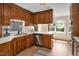 This functional kitchen features wood cabinets, stainless steel dishwasher, and a sunlit breakfast nook at 603 Warren Rd, Erwin, NC 28339