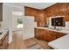 A partial view of a well-lit kitchen with wood cabinets, white countertops and views into the dining room at 603 Warren Rd, Erwin, NC 28339