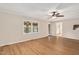Bright living room features wood-look flooring, a ceiling fan, and access to other rooms of the house at 603 Warren Rd, Erwin, NC 28339