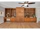Living room features hardwood floors, a ceiling fan, and custom-built wood shelving for organization and decor at 603 Warren Rd, Erwin, NC 28339
