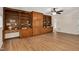 Spacious living room featuring hardwood floors, a ceiling fan and custom wood built-in shelving at 603 Warren Rd, Erwin, NC 28339