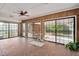 Enclosed sunroom with tile flooring, a ceiling fan, and sliding glass doors to the backyard at 603 Warren Rd, Erwin, NC 28339