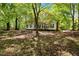 Quaint single-story home with brick chimney nestled among mature trees on a spacious lot at 606 Dennys Store Rd, Roxboro, NC 27574