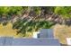 Aerial view of the backyard, screened porch and green tree surroundings at 608 Cormiche Ln, Wake Forest, NC 27587