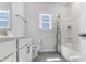 Bright bathroom featuring tiled floors, a window, and a shower with a curtain at 608 Cormiche Ln, Wake Forest, NC 27587