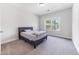 Carpeted bedroom with a large window showing views of the neighborhood at 608 Cormiche Ln, Wake Forest, NC 27587