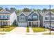 Desirable two-story home featuring a two-car garage, front lawn, and classic architectural design at 608 Cormiche Ln, Wake Forest, NC 27587