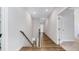 Upstairs hallway with hardwood floors and natural light from the doorway at 608 Cormiche Ln, Wake Forest, NC 27587