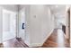 Bright hallway with gleaming hardwood floors, leading to carpeted rooms and offering seamless transitions at 608 Cormiche Ln, Wake Forest, NC 27587