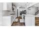 Modern kitchen with white cabinets, stainless steel appliances, an island with sink, and hardwood floors at 608 Cormiche Ln, Wake Forest, NC 27587