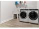 Well-equipped laundry room featuring a sink, shelving, and modern washer and dryer at 608 Cormiche Ln, Wake Forest, NC 27587