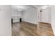 Bright living room features hardwood floors, large windows, and modern light fixtures at 608 Cormiche Ln, Wake Forest, NC 27587