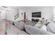 Comfortable living room with hardwood floors, a large sectional sofa, and modern entertainment setup at 608 Cormiche Ln, Wake Forest, NC 27587