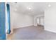 Spacious living area with neutral carpet, recessed lighting, and French doors for a versatile space at 608 Cormiche Ln, Wake Forest, NC 27587