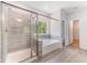 Luxurious bathroom with a soaking tub, separate shower, and stylish tile at 608 Cormiche Ln, Wake Forest, NC 27587