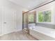 Luxurious bathroom with a soaking tub, separate shower, and stylish tile at 608 Cormiche Ln, Wake Forest, NC 27587