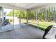 Spacious screened porch with open view to backyard with lush lawn and wooded perimeter at 608 Cormiche Ln, Wake Forest, NC 27587