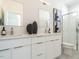 Modern bathroom with dual sinks, sleek cabinetry, and a glass-enclosed shower at 611 Walnut Hts Dr # 101, Raleigh, NC 27610