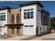 Modern townhome features sleek white and wood paneling with large windows and an attached garage at 611 Walnut Hts Dr # 101, Raleigh, NC 27610