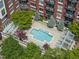 Overhead view showcasing a building's pool and deck, surrounded by lush trees and landscaping at 618 N Boylan Ave # 400, Raleigh, NC 27603