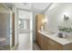 Bathroom featuring a shower, wooden vanity, and a large mirror, with a view into the bedroom at 618 N Boylan Ave # 400, Raleigh, NC 27603