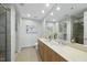 Well-lit bathroom features double sinks, a large mirror, and tiled floors at 618 N Boylan Ave # 400, Raleigh, NC 27603