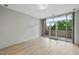 Bright bedroom with light hardwood floors and a glass door that opens to a balcony at 618 N Boylan Ave # 400, Raleigh, NC 27603