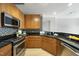 Well-lit kitchen boasts black granite countertops and stainless steel appliances for a modern aesthetic at 618 N Boylan Ave # 400, Raleigh, NC 27603